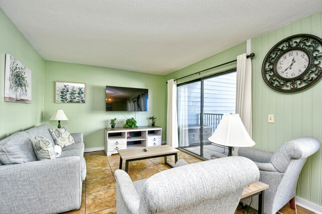 5905 S Kings Hwy Unit 116B, Myrtle Beach, SC 29575 - tiled living room with a textured ceiling and baseboards