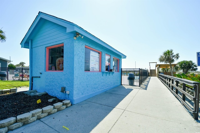 5905 S Kings Hwy Unit 116B, Myrtle Beach, SC 29575 - view of side of property featuring stucco siding and fence