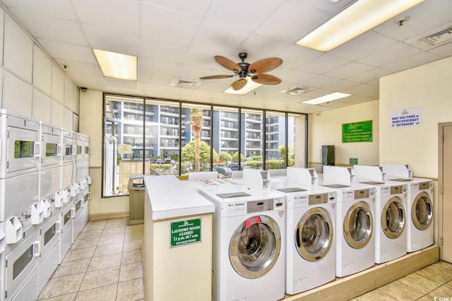 5905 S Kings Hwy Unit 116B, Myrtle Beach, SC 29575 - communal laundry room featuring stacked washing machine and dryer, washing machine and dryer, a ceiling fan, and light tile patterned floors
