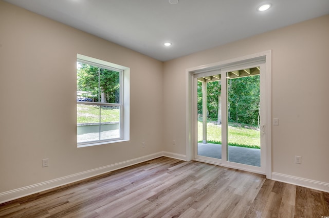 1673 Carriage Ln, Little River, SC 29566 - empty room featuring plenty of natural light, light wood-style flooring, baseboards, and recessed lighting