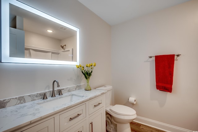 1673 Carriage Ln, Little River, SC 29566 - bathroom with toilet, wood finished floors, a shower, vanity, and baseboards