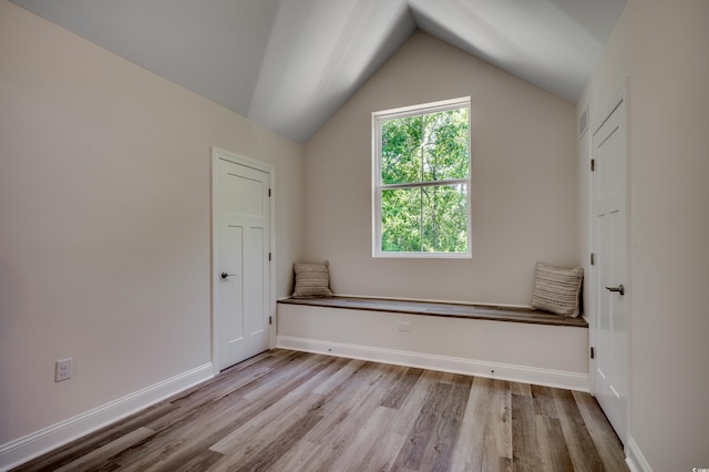 1673 Carriage Ln, Little River, SC 29566 - unfurnished room featuring wood finished floors, vaulted ceiling, and baseboards