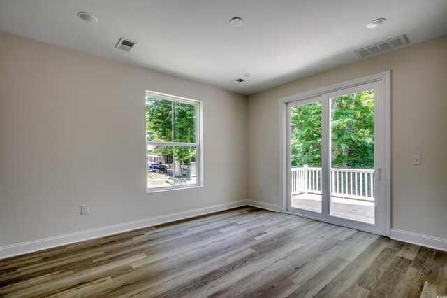 1673 Carriage Ln, Little River, SC 29566 - spare room with wood finished floors, plenty of natural light, and baseboards