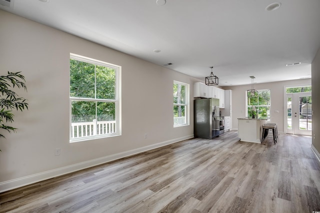 1673 Carriage Ln, Little River, SC 29566 - living area with light wood-style flooring, plenty of natural light, and baseboards
