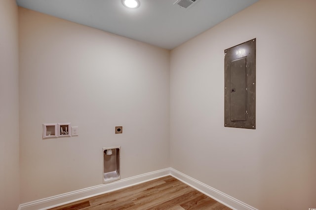 1673 Carriage Ln, Little River, SC 29566 - clothes washing area with electric panel, washer hookup, electric dryer hookup, baseboards, and light wood-style floors