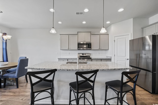 4410 Honir Dr, Myrtle Beach, SC 29579 - kitchen with appliances with stainless steel finishes, a sink, decorative backsplash, a kitchen breakfast bar, and recessed lighting