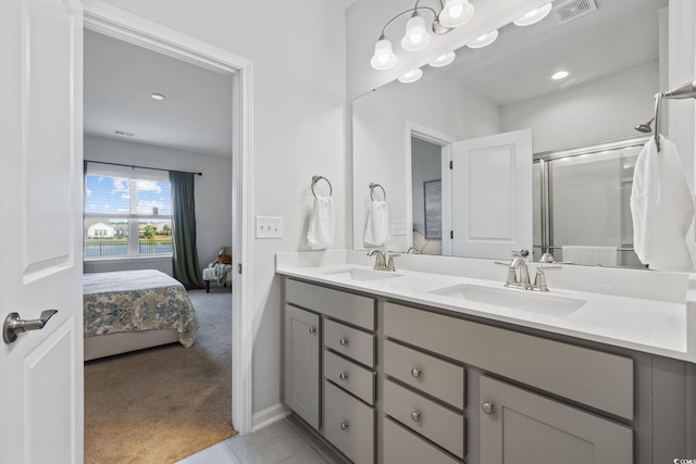 4410 Honir Dr, Myrtle Beach, SC 29579 - bathroom with double vanity, ensuite bath, an enclosed shower, tile patterned floors, and baseboards