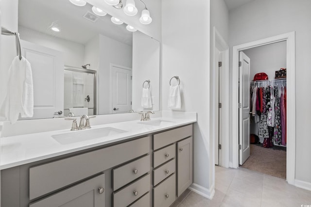 4410 Honir Dr, Myrtle Beach, SC 29579 - full bath with tile patterned flooring, double vanity, a stall shower, baseboards, and a spacious closet