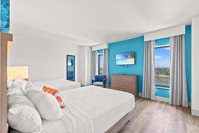 3000 N Ocean Blvd N Unit 1401, Myrtle Beach, SC 29577 - bedroom with light wood finished floors, multiple windows, and baseboards