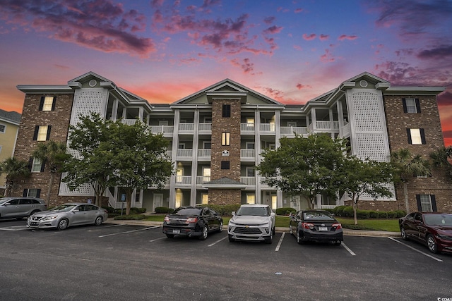 4895 Luster Leaf Cir Unit 302, Myrtle Beach, SC 29577 - property at dusk with uncovered parking