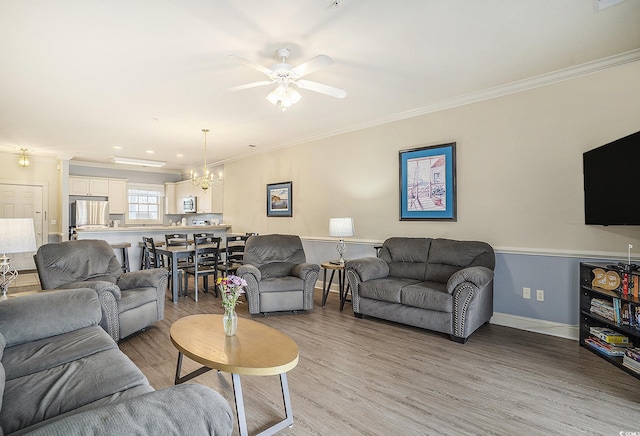 4895 Luster Leaf Cir Unit 302, Myrtle Beach, SC 29577 - living area with crown molding, light wood-type flooring, a chandelier, a ceiling fan, and baseboards