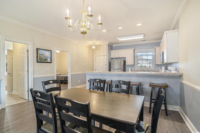 4895 Luster Leaf Cir Unit 302, Myrtle Beach, SC 29577 - dining room featuring a chandelier, ornamental molding, light wood-style floors, recessed lighting, and baseboards