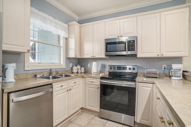4895 Luster Leaf Cir Unit 302, Myrtle Beach, SC 29577 - kitchen featuring stainless steel appliances, a sink, crown molding, light countertops, and light tile patterned floors
