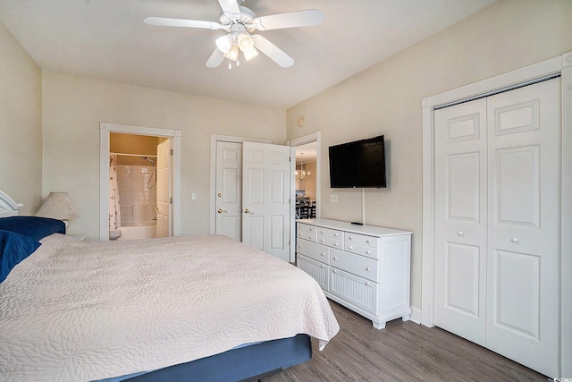 4895 Luster Leaf Cir Unit 302, Myrtle Beach, SC 29577 - bedroom featuring wood finished floors, ensuite bathroom, ceiling fan, multiple closets, and baseboards