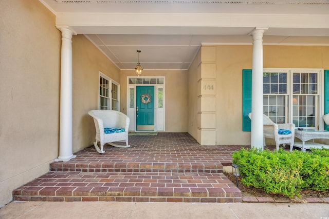 444 Dornoch Dr, Pawleys Island, SC 29585 - view of exterior entry with a porch and stucco siding