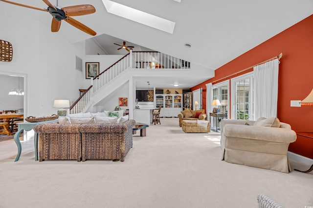 444 Dornoch Dr, Pawleys Island, SC 29585 - living area featuring carpet, ceiling fan, stairway, high vaulted ceiling, and a skylight