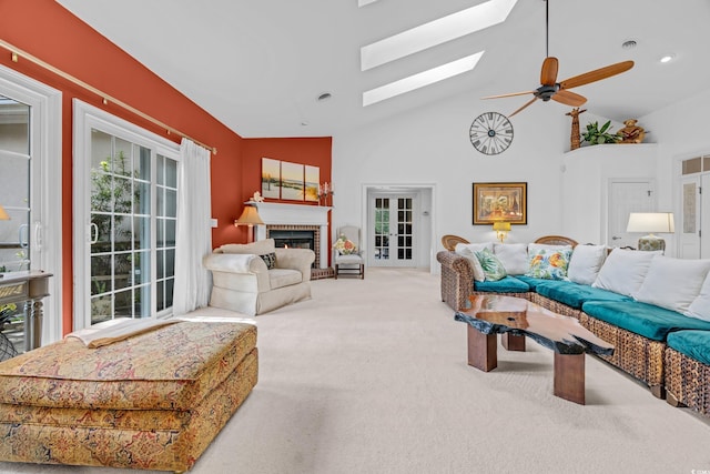 444 Dornoch Dr, Pawleys Island, SC 29585 - carpeted living room with a fireplace, a skylight, a ceiling fan, and high vaulted ceiling