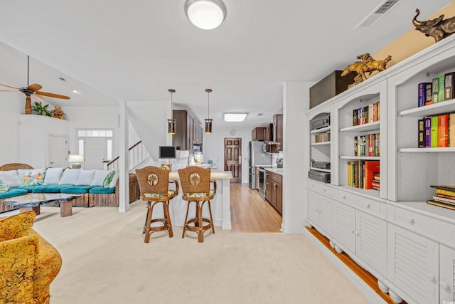 444 Dornoch Dr, Pawleys Island, SC 29585 - dining space featuring ceiling fan, light colored carpet, and stairway