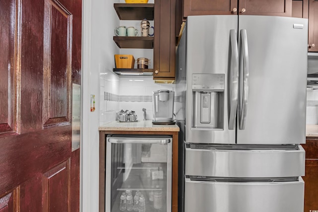 444 Dornoch Dr, Pawleys Island, SC 29585 - kitchen featuring stainless steel refrigerator with ice dispenser, wine cooler, open shelves, and light stone countertops