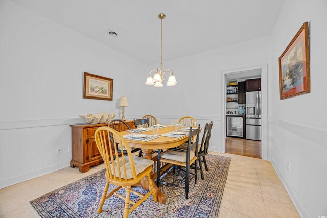 444 Dornoch Dr, Pawleys Island, SC 29585 - dining space with a chandelier, wine cooler, and light tile patterned floors