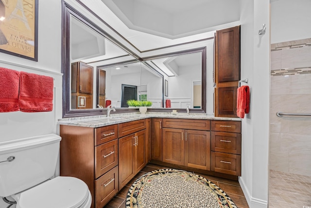 444 Dornoch Dr, Pawleys Island, SC 29585 - full bathroom featuring toilet, double vanity, a tile shower, and wood finished floors