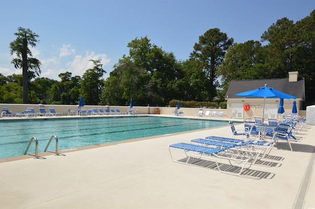 444 Dornoch Dr, Pawleys Island, SC 29585 - community pool with a patio area and view of wooded area