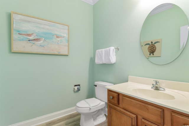 703 S Waccamaw Dr, Garden City Beach, SC 29576 - bathroom with baseboards, vanity, toilet, and wood finished floors