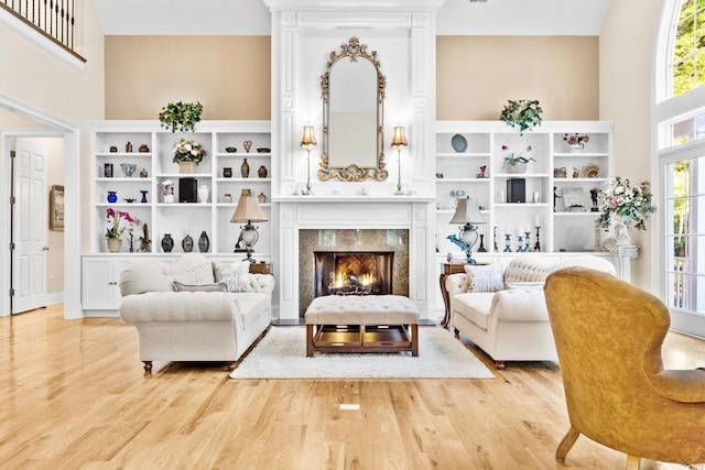 509 Heston Point Dr, Pawleys Island, SC 29585 - living room featuring light wood finished floors, a towering ceiling, and a premium fireplace