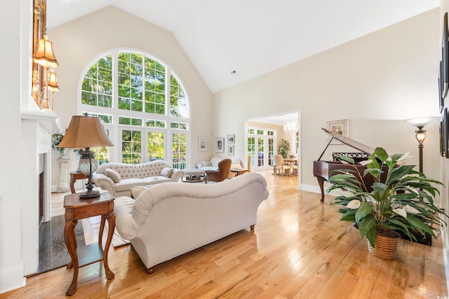 509 Heston Point Dr, Pawleys Island, SC 29585 - living room with high vaulted ceiling, a chandelier, healthy amount of natural light, and light wood-type flooring