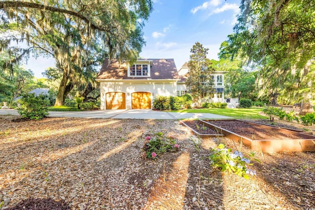 509 Heston Point Dr, Pawleys Island, SC 29585 - view of front of house with a vegetable garden, a garage, driveway, and roof with shingles