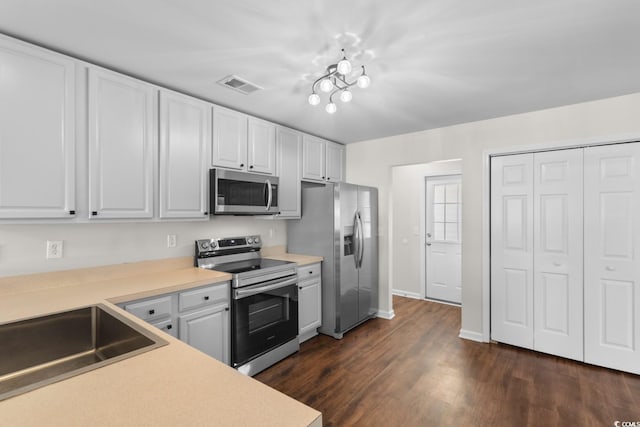 2072 Haystack Way, Myrtle Beach, SC 29579 - kitchen with stainless steel appliances, light countertops, white cabinets, and dark wood-type flooring