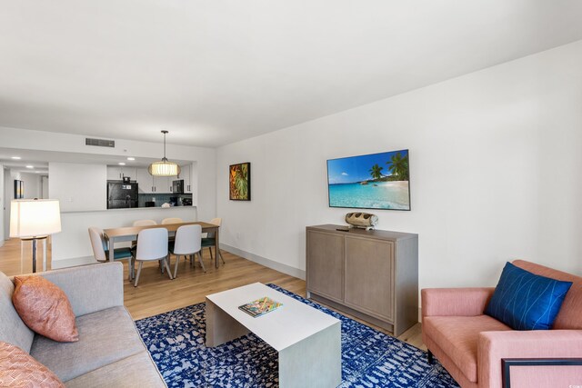 7100 N Ocean Blvd N Unit 321, Myrtle Beach, SC 29572 - living area featuring light wood-style floors and baseboards