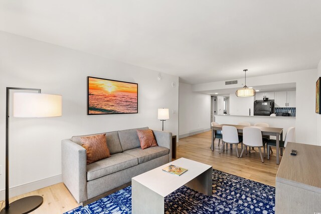 7100 N Ocean Blvd N Unit 321, Myrtle Beach, SC 29572 - living room with light wood-type flooring and baseboards