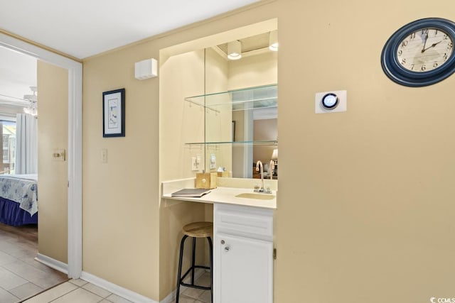 207 N 3rd Ave N Unit 247, North Myrtle Beach, SC 29582 - ensuite bathroom with vanity, tile patterned floors, and baseboards