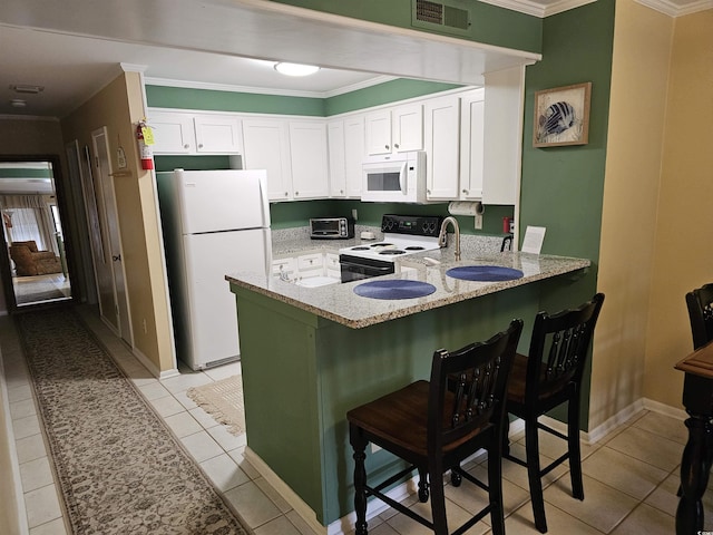 207 N 3rd Ave N Unit 247, North Myrtle Beach, SC 29582 - kitchen with white appliances, a peninsula, ornamental molding, light stone counters, and white cabinets