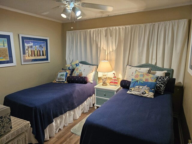 207 N 3rd Ave N Unit 247, North Myrtle Beach, SC 29582 - bedroom with wood finished floors, ornamental molding, and a ceiling fan