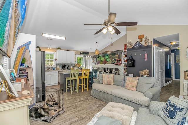 3827 El Duce Pl, Myrtle Beach, SC 29588 - living area with vaulted ceiling, light wood-type flooring, and a ceiling fan