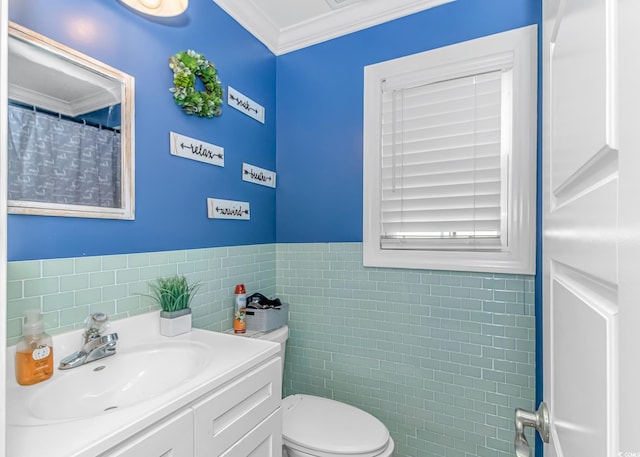 3827 El Duce Pl, Myrtle Beach, SC 29588 - full bathroom featuring tile walls, ornamental molding, toilet, vanity, and a wainscoted wall