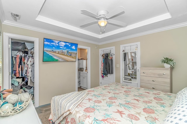 3827 El Duce Pl, Myrtle Beach, SC 29588 - bedroom featuring a tray ceiling, a closet, a walk in closet, crown molding, and ensuite bathroom