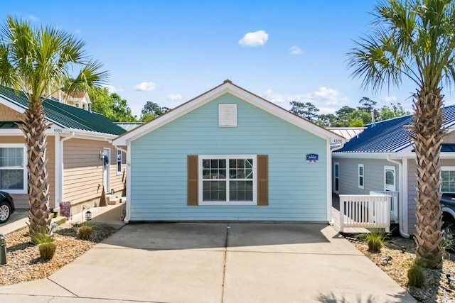 4338 Grande Harbour Blvd, Little River, SC 29566 - view of front of home with metal roof and concrete driveway