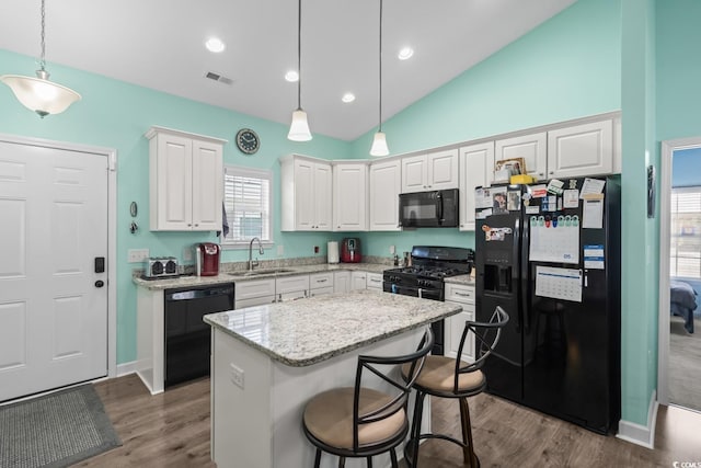 4338 Grande Harbour Blvd, Little River, SC 29566 - kitchen featuring black appliances, a sink, white cabinets, dark wood-type flooring, and a center island