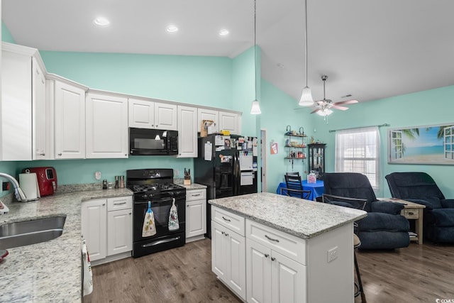 4338 Grande Harbour Blvd, Little River, SC 29566 - kitchen with black appliances, a sink, open floor plan, white cabinetry, and high vaulted ceiling