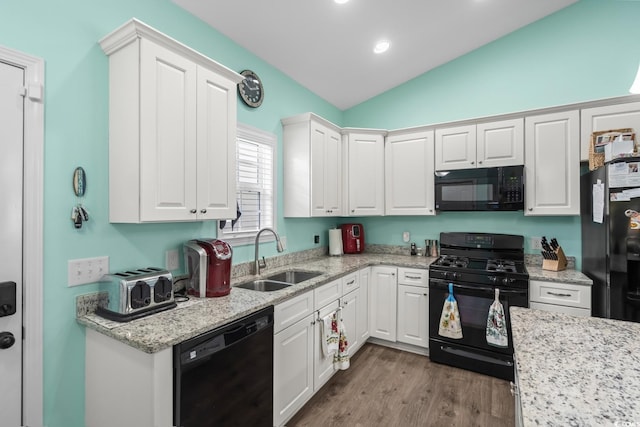 4338 Grande Harbour Blvd, Little River, SC 29566 - kitchen with black appliances, a sink, lofted ceiling, white cabinets, and wood finished floors
