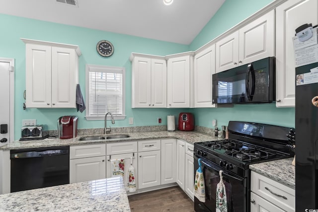 4338 Grande Harbour Blvd, Little River, SC 29566 - kitchen featuring black appliances, a sink, white cabinetry, dark wood finished floors, and light stone countertops