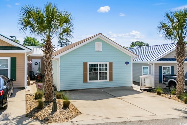 4338 Grande Harbour Blvd, Little River, SC 29566 - single story home featuring a standing seam roof, metal roof, and driveway