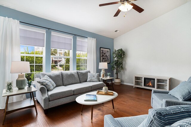 3210 Volterra Way Unit 3210, Myrtle Beach, SC 29579 - living room with vaulted ceiling, ceiling fan, wood finished floors, a glass covered fireplace, and baseboards