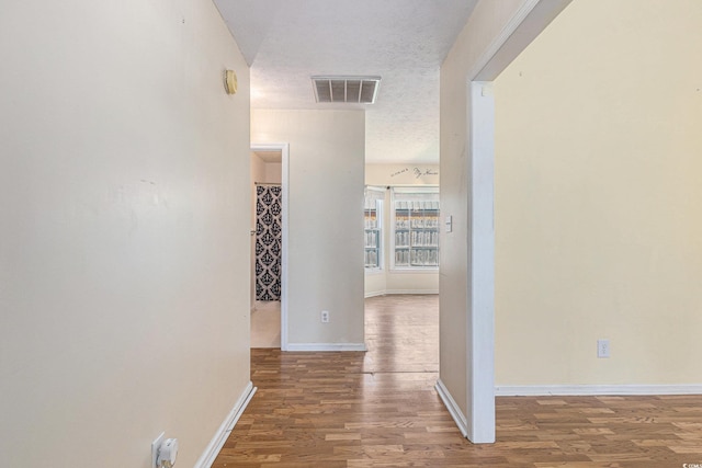 3429 Mishoe St, Loris, SC 29569 - corridor with wood finished floors and a textured ceiling