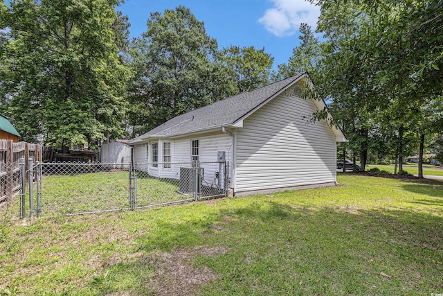 3429 Mishoe St, Loris, SC 29569 - view of side of home with a gate, a storage unit, and a shingled roof