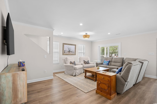 living area with crown molding, wood finished floors, baseboards, and recessed lighting