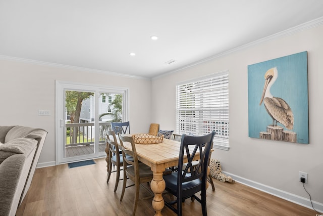 dining space featuring ornamental molding, wood finished floors, baseboards, and recessed lighting